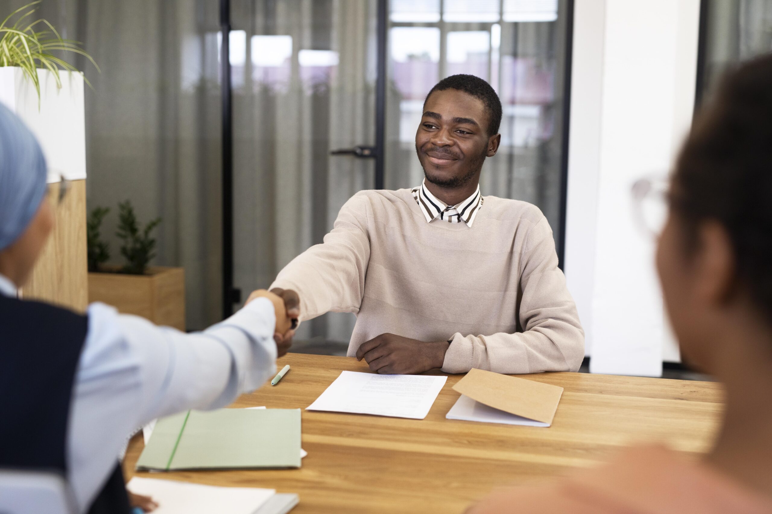 man-handshaking-his-employer-after-being-accepted-his-new-office-job